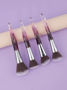 Detailed view of four crystal makeup brushes with gradient handles and soft fibers