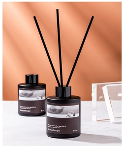 Close-up of black glass aromatherapy diffuser bottles with natural herbal essential oil