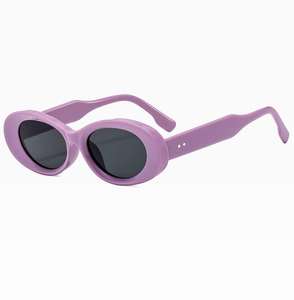 Side view of vintage thick purple oval sunglasses with dark lenses and silver stud details