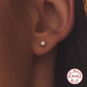 Classic 925 sterling silver six-prong cubic zirconia stud earrings worn on ear