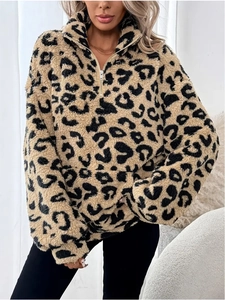Detailed close-up of leopard print faux fur texture and metal half-zipper on the pullover