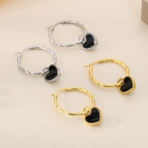 Detail of twisted rope hoops with black enamel heart charms in gold and silver finish