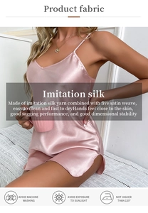Detailed view of pink silk satin nightgown fabric texture with v-neckline and thin straps