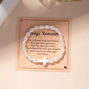 Fashion cross pendant bracelet set with white faux pearl beads on a display card