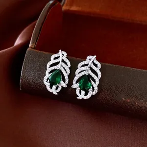 Silver leaf earrings featuring pear-cut green zircon and shimmering pavé stone accents