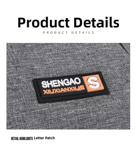 Macro view of the 3D silicone logo plaque on the durable grey oxford sports waist bag