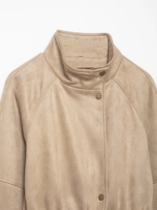Detail of khaki suede jacket featuring stand collar and vintage metallic snap buttons