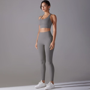 Detail of grey seamless yoga set featuring high waist leggings and racerback sports bra