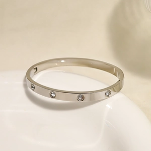 Close-up of silver titanium steel bracelet featuring detailed round cubic zirconia inlay