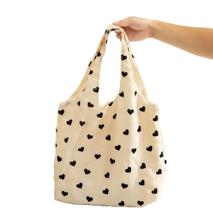 Large capacity cream textured canvas tote bag with black heart pattern print design