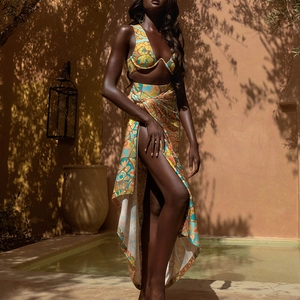 Detailed pattern of ethnic print bikini top and matching sarong in a resort setting