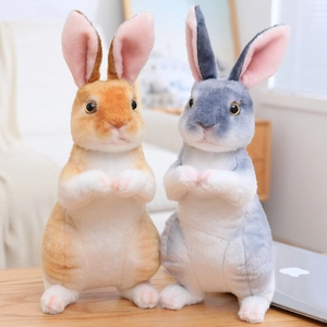 Detailed view of plush sitting rabbits in grey-blue and orange-brown fluffy fur