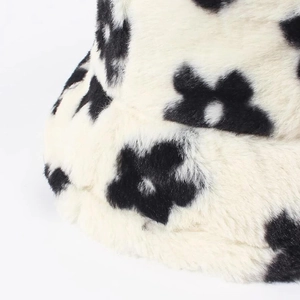 Winter plush bucket hat with black flower patterns and soft faux fur texture for women