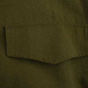 Detailed close-up of military green twill fabric pocket and premium stitching on dress