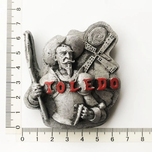 Detail view of Toledo metal fridge magnet featuring Don Quixote and windmill with ruler size