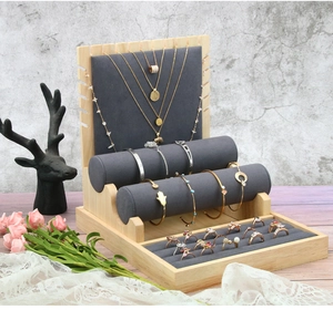 Bamboo jewelry stand with grey microfiber inserts for rings and necklaces in macro detail