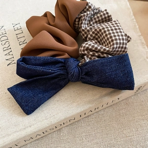 Detailed view of the fabric mesh bow scrunchie with mixed vintage textures and patterns