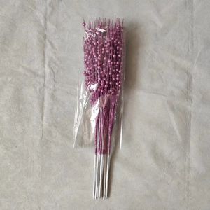 Detail of glittery pink berry stem in transparent packaging for Christmas tree decor