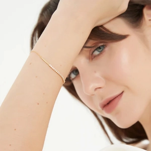 Detail of elegant gold S925 sterling silver bracelet with cubic zirconia on model wrist