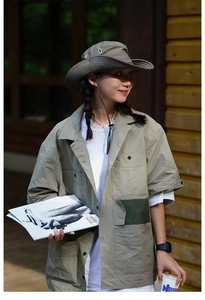 Outdoor sun hat with adjustable drawstring shown in a stylish camping lifestyle scene