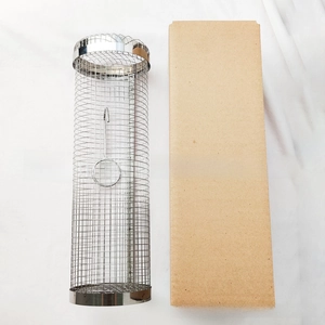 Macro detail of cylindrical stainless steel BBQ grill basket with its craft paper box
