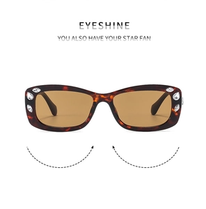 Detail of tortoiseshell sunglasses frame with sparkling crystals and brown lenses