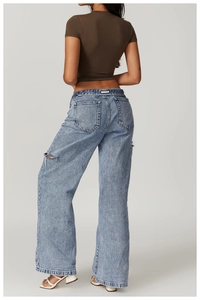 Slim fit brown athletic crop top paired with light blue distressed wide leg denim jeans