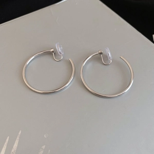 Polished silver hoop clip-on earrings with clear silicone pads for non-pierced ears