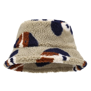 Beige faux fur bucket hat with blue and brown patchwork design for winter warmth
