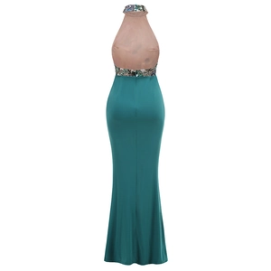 Detail of teal halter evening gown featuring intricate floral embroidery and mesh back