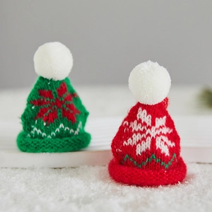 Mini knitted Christmas hats with snowflake patterns and fluffy pom-poms for tree decor