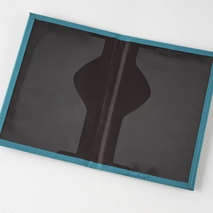 Blue PU leather passport cover detail showing internal transparent slots and card holders for travel.