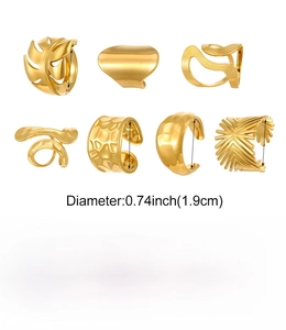Detailed view of 7 irregular gold stainless steel rings with geometric leaf and wave motifs