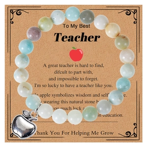 Detail of beaded teacher bracelet with silver apple charm and thank you card