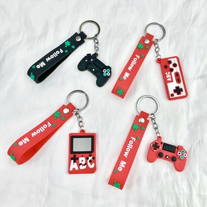 Close-up of silicone game controller keychains with Follow Me text and metal rings