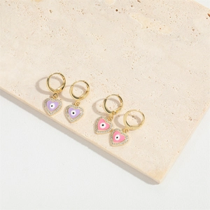 Golden hoop earrings featuring heart charms with evil eye motifs and purple pink enamel