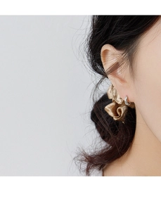 Close-up of S925 sterling silver hoop earring with irregular textured finish on ear