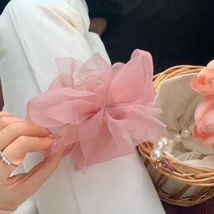 Macro detail of the light pink organza floral hair claw clip with a transparent base