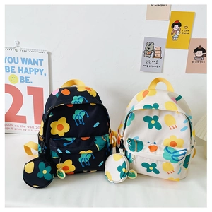 Detail of floral printed kids backpack and matching pouch with yellow handle strap