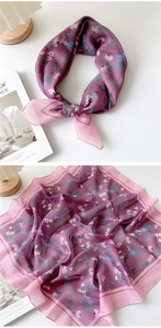 Detail of floral cotton linen scarf with purple and pink patterns and delicate hem