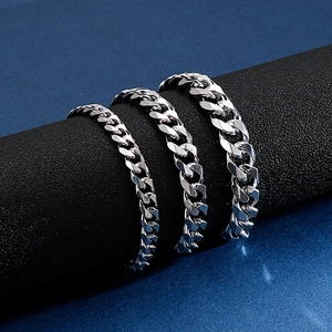 Three widths of silver stainless steel curb chain bracelets for men on a display stand