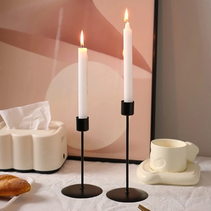 Pair of modern black matte metal candle holders for romantic dinner table decor