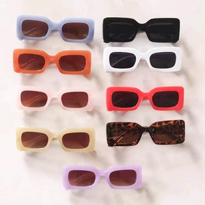 Flat lay of retro rectangular sunglasses in nine vibrant colors for fashion styling
