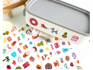 Detailed view of colorful cartoon stickers applied on a white lunch box surface