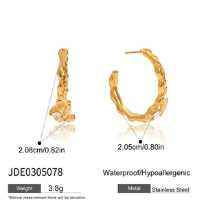 Detailed view of gold lava texture stainless steel hoop earrings with clear zircon stones