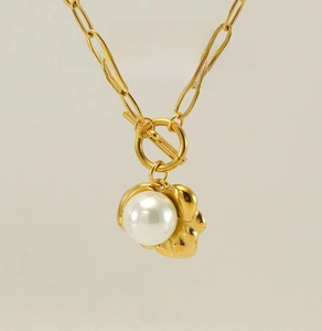 Close-up of gold stainless steel toggle clasp necklace with a round white pearl pendant
