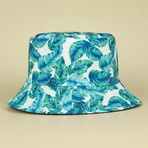 Reversible bucket hat with tropical green palm leaf print on white cotton fabric