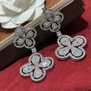 Silver four-leaf clover drop earrings with zircon crystals and hollow floral design