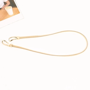 Close-up of golden metal elastic snake chain waist belt with minimalist hook closure