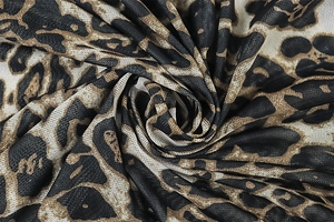 Detailed macro view of lightweight leopard print fabric with breathable mesh texture